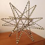 Straw star made from black and gold striped straws