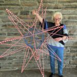April holding a USA flag colored mega star made in honor of America's 250th birthday