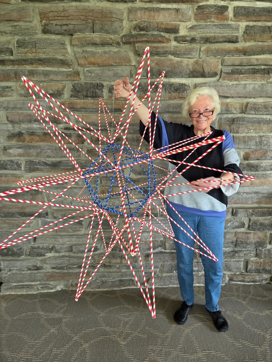 April holding a USA flag colored mega star made in honor of America's 250th birthday